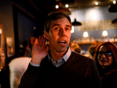 Former Texas Congressman and Democratic party presidential candidate Beto O'Rourke leans in to hear a comment after speaking to diners at The Pig & Porter restaurant in Cedar Rapids, Iowa, on March 15, 2019.