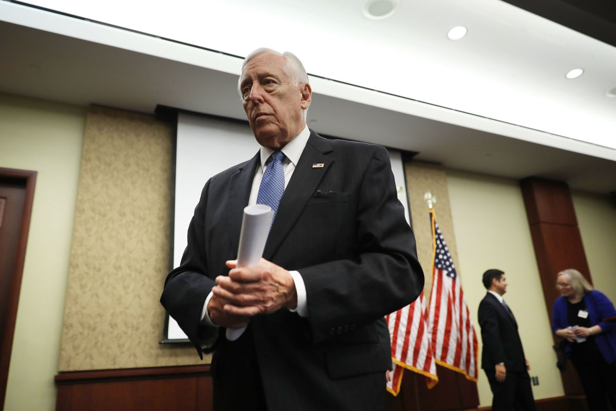 Steny Hoyer walks away from podium with a rolled up piece of paper