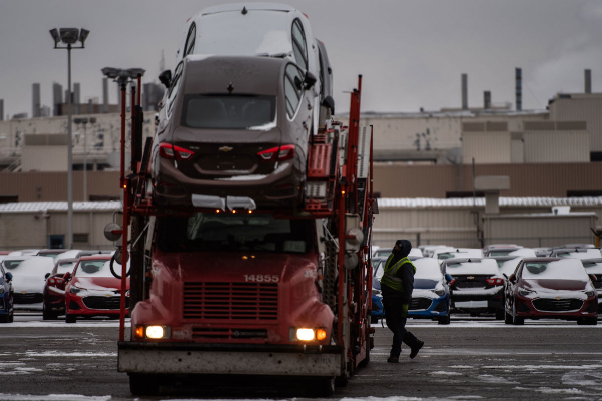 Employee checks cars on a truck at the General Motors plant in Lordstown, Ohio