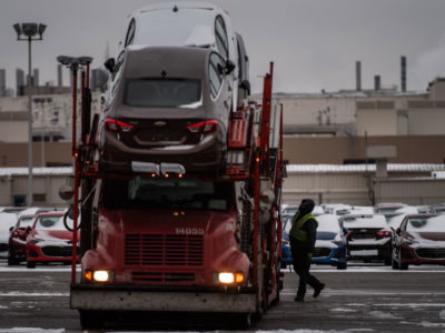 Employee checks cars on a truck at the General Motors plant in Lordstown, Ohio