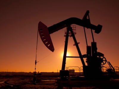 Silhouette of oil pump jack on rig