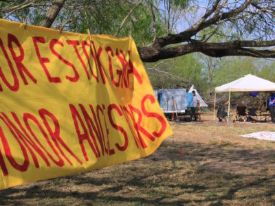 A banner at the Yalui camp at the Eli Jackson Cemetery in San Juan, Texas, on March 1, 2019.