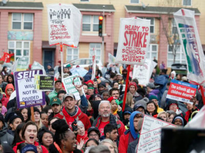 Teachers, students and supporters attend a rally at Roots International Academy after a march down International Boulevard in Oakland, Calif., on Tuesday, Feb. 26, 2019.