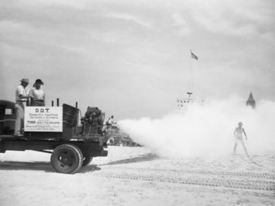 Beachgoers are sprayed with DDT as a new machine for distributing the insecticide is tested for the first time on July 8, 1945.