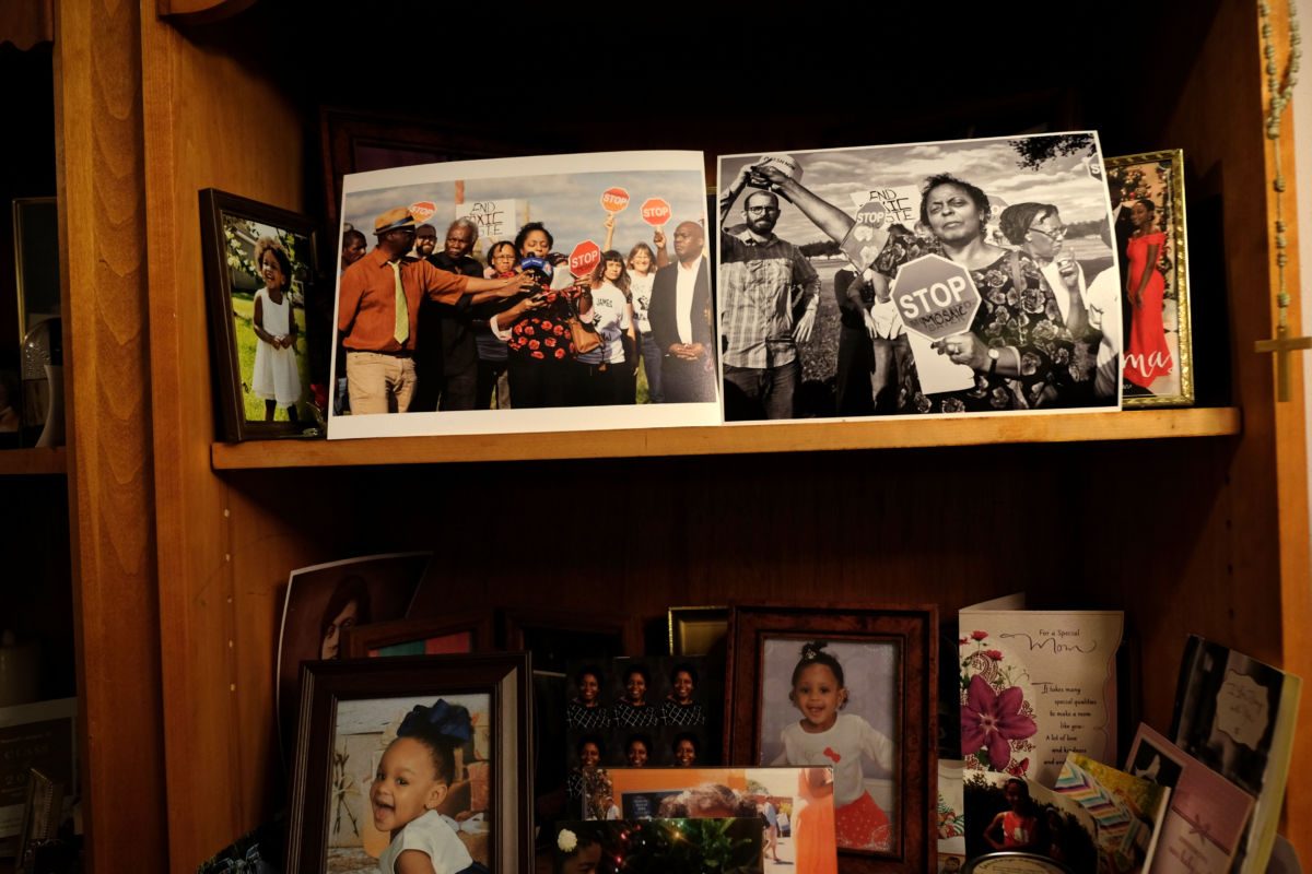 A shelf in Sharon Lavigne's living room displays photos of her family and her activism. Lavigne's father fought to desegregate the high school where she works as a teacher. 