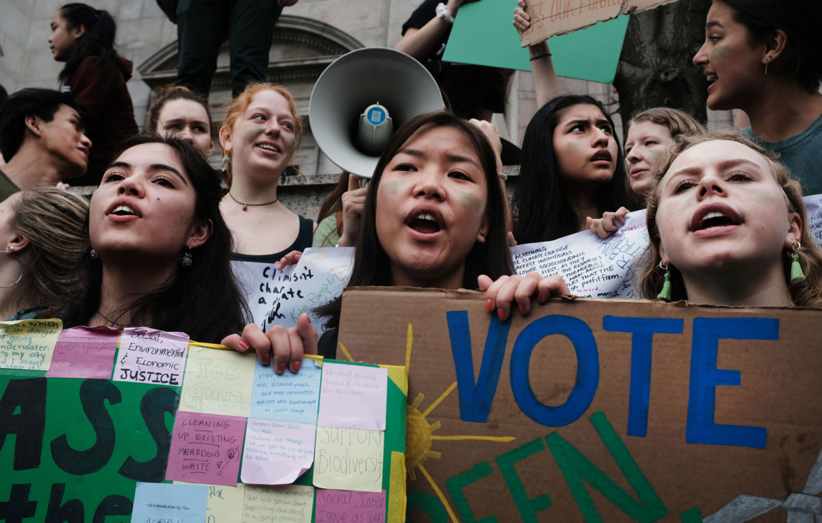 Students participate in a collective climate action in front of the Museum of Natural History