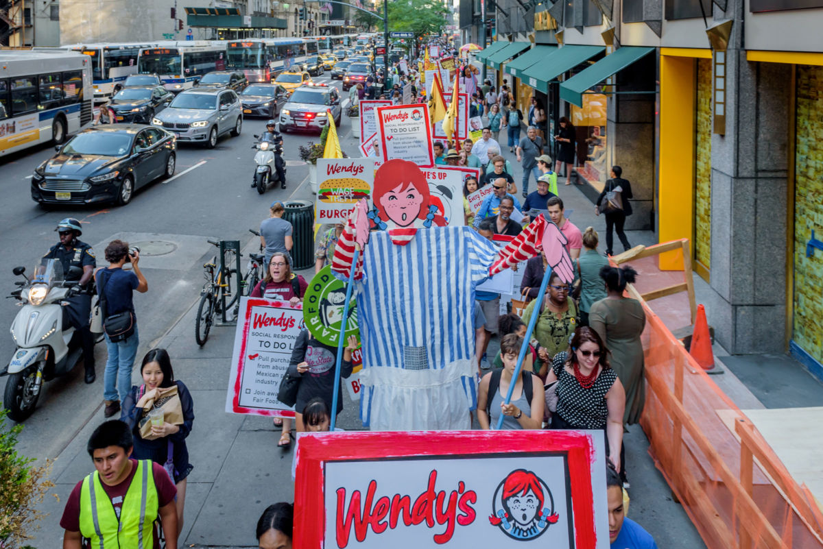 Protesters with Wendy prop in front of Wendy's owner Nelson Peltz's offices