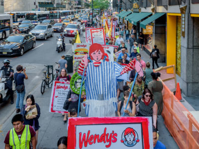 Protesters with Wendy prop in front of Wendy's owner Nelson Peltz's offices