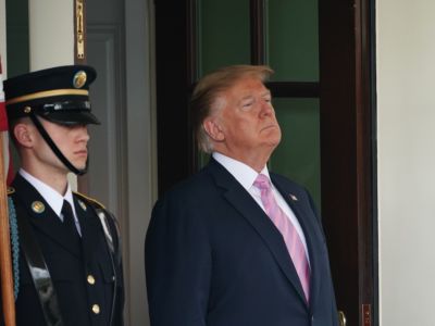 Donald Trump stands in a doorway at the White House