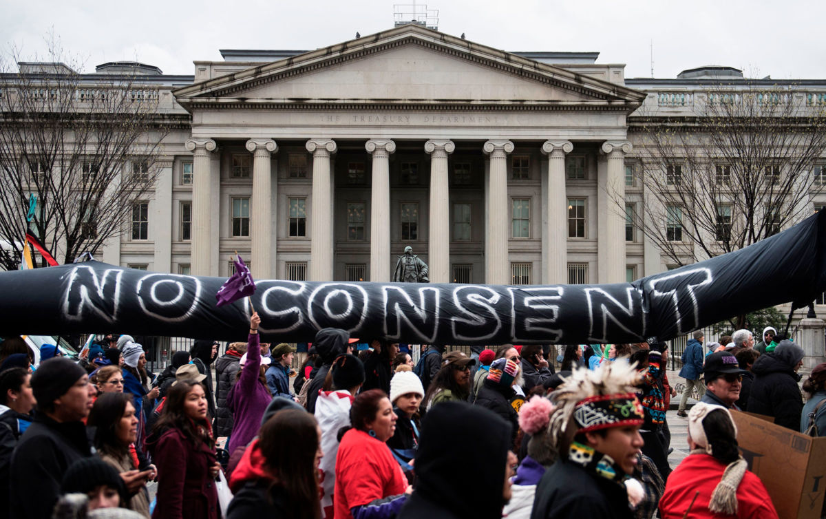 Activists rallying for Native American rights march past the U.S. Treasury Department during the Native Nations Rise protest March 10, 2017, in Washington, D.C.