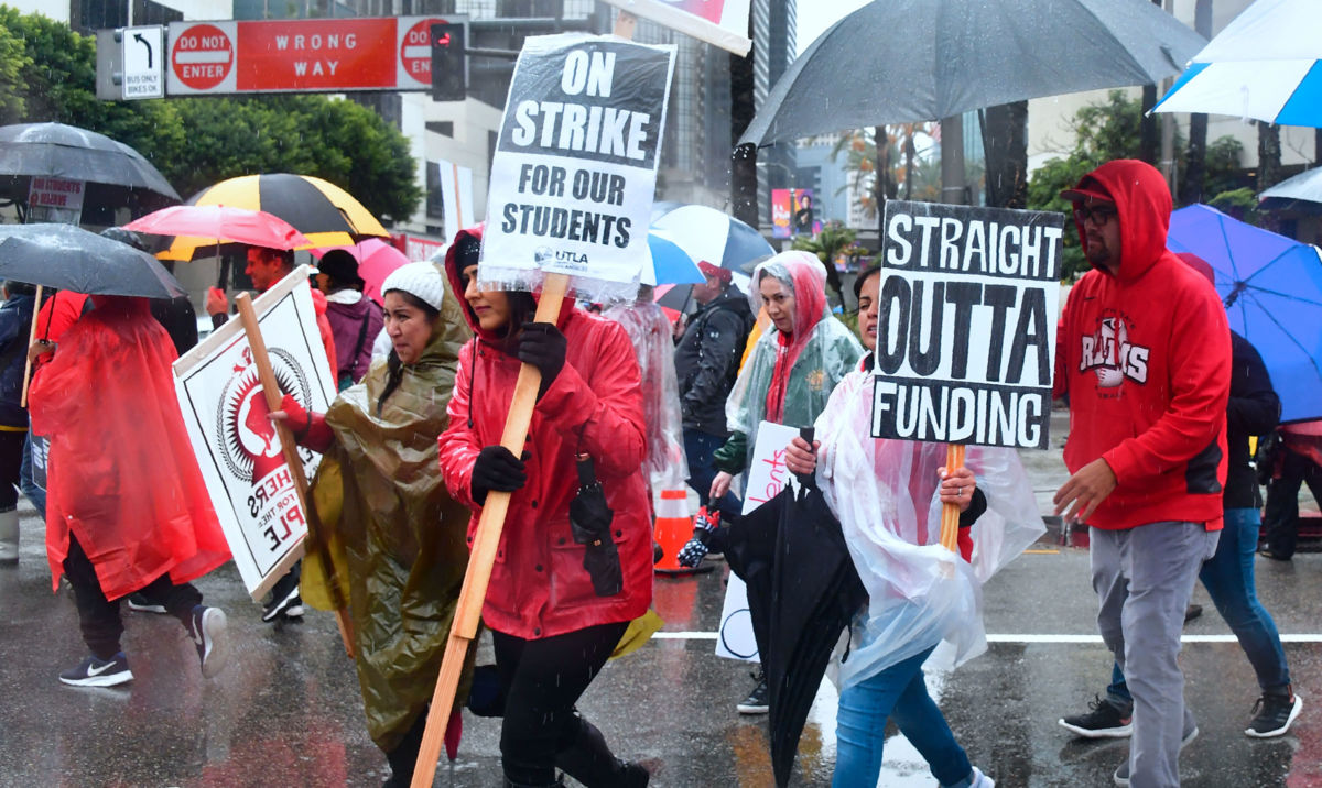 Thousands of teachers march in the rain during teachers strike in Los Angeles