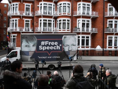 A van bearing a message in support of Chelsea Manning and Julian Assange sits outside an apartment complex