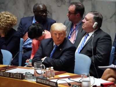 Donald trump sits with his arms crossed at the United Nations