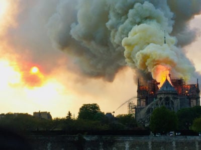 Notre Dame Cathedrial burns as plumes of smoke rise into the sky
