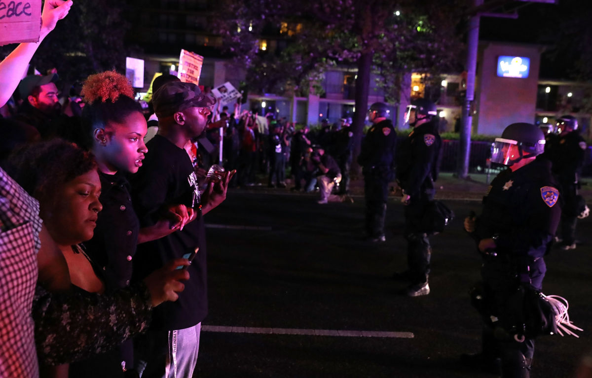 Black Lives Matter protesters confront a line of California Highway Patrol officers during a demonstration on March 30, 2018, in Sacramento, California.