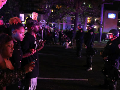 Black Lives Matter protesters confront a line of California Highway Patrol officers during a demonstration on March 30, 2018, in Sacramento, California.