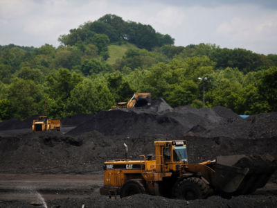 Caterpillar front-loading machinery operates on mounds of coal at Arch Coal Terminals, June 3, 2014, in Cattletsburg, Kentucky.