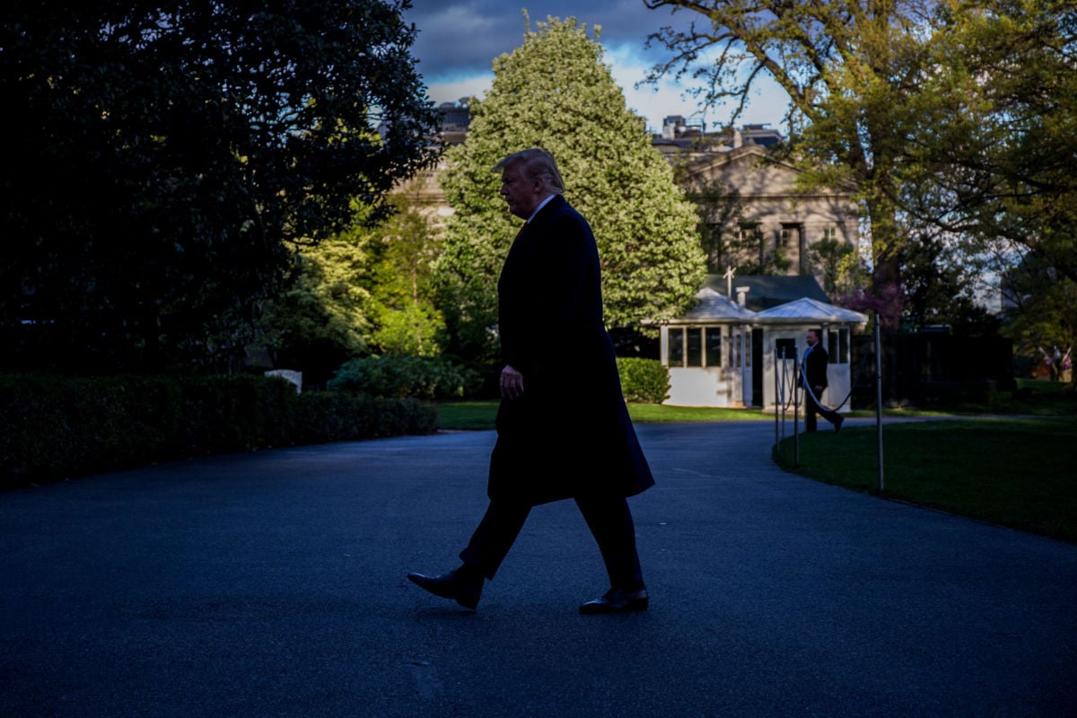 President Trump walks in shade on return to the White House