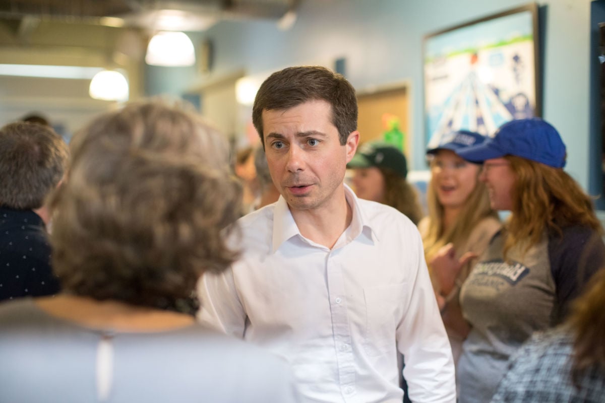 Pete Buttigieg talks to supporters in a small crowd