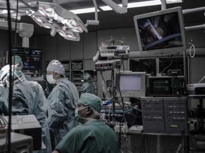 A group of doctors in the middle of surgery.