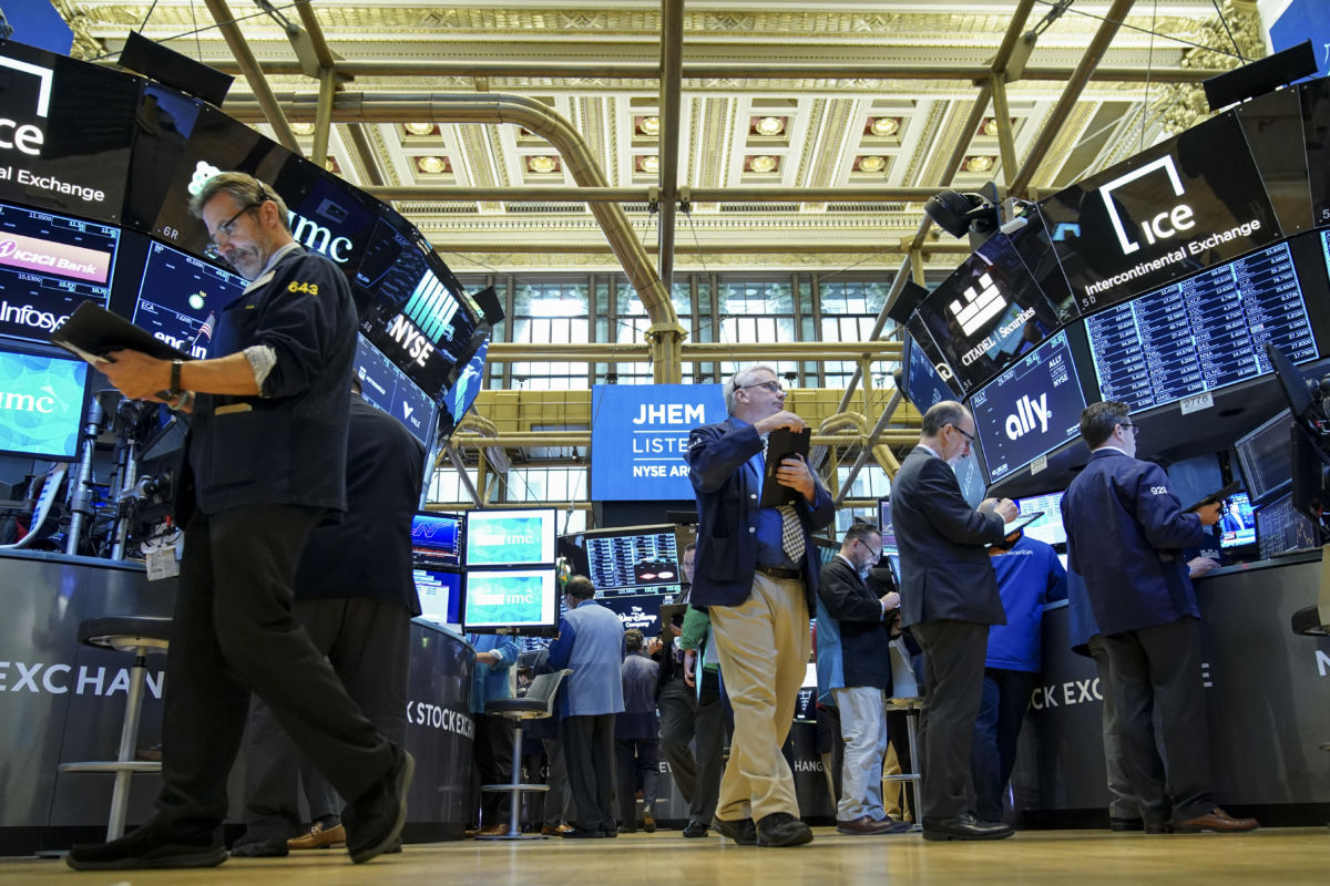 Traders and financial professionals work on the floor of the New York Stock Exchange (NYSE) at the opening bell, April 24, 2019 in New York City.