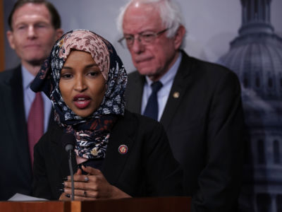 Rep. Ilhan Omar speaks into a microphone