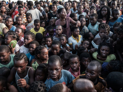 Children wait to receive food distribution from a local supermarket at an evacuation center in Dondo, about 35km north from Beira, Mozambique, on March 27, 2019.