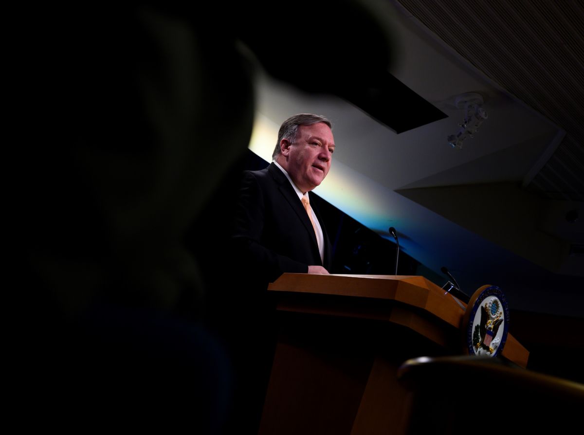 Mike Pompeo speaks at a podium with a darkened foreground