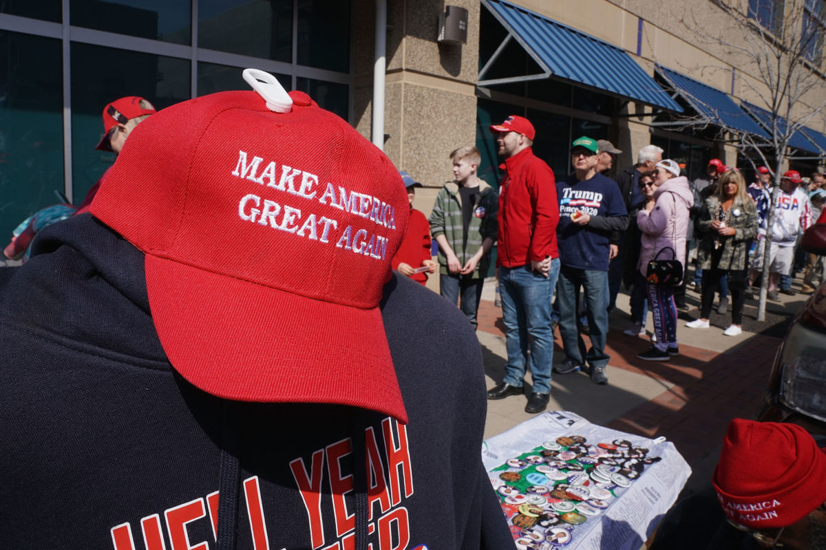 A MAGA hat is seen along with other Trump merchandise