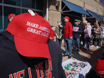 A MAGA hat is seen along with other Trump merchandise