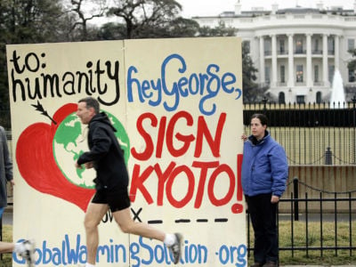 An activist protests President George W. Bush's withdrawal of support for the Kyoto Protocol near the White House. The U.S. had withdrawn from the treaty citing a lack of scientific evidence on global warming. New documents reveal the U.S. State Department gave the Global Climate Coalition credit for leading Bush to reject the landmark treaty in 2001.