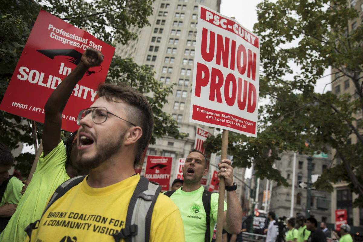 People hold pro-union signs during a rally