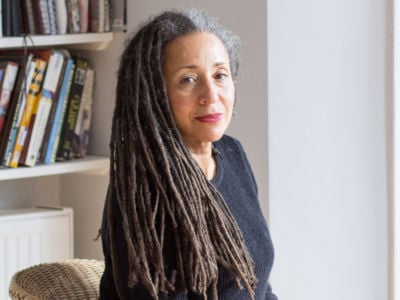 Jackie Walker, wearing a black shirt, sits in a chair