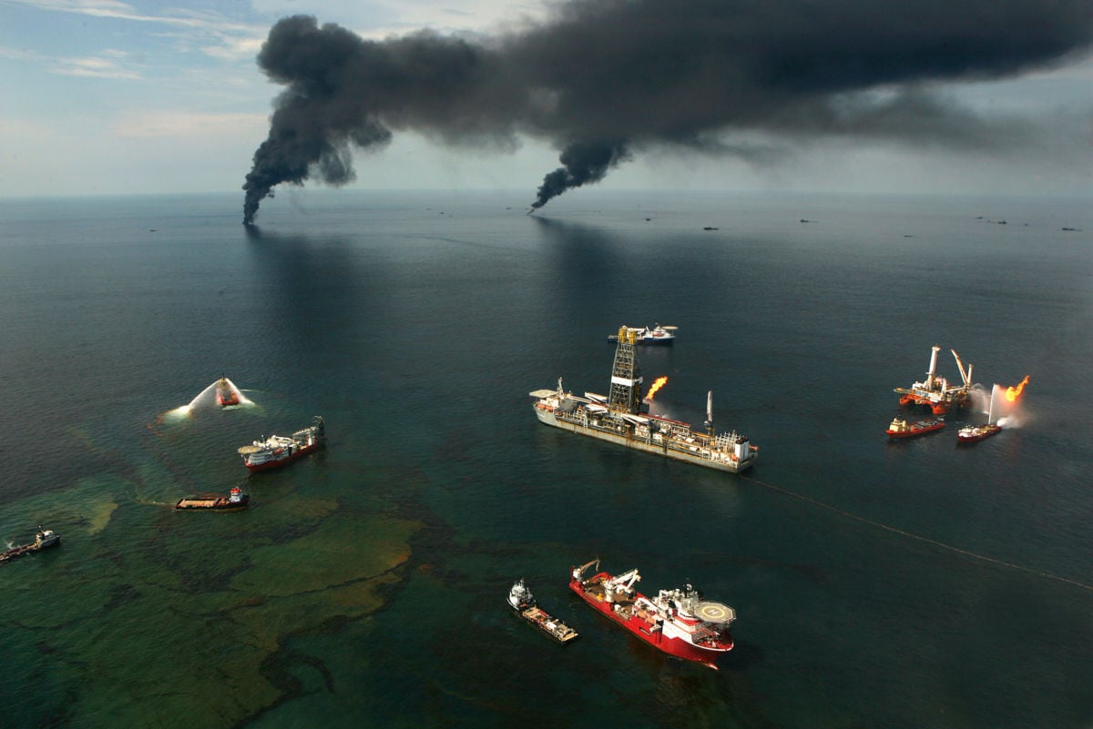 Pillars of smoke rise from the ruins of Deepwater Horizon in the ocean