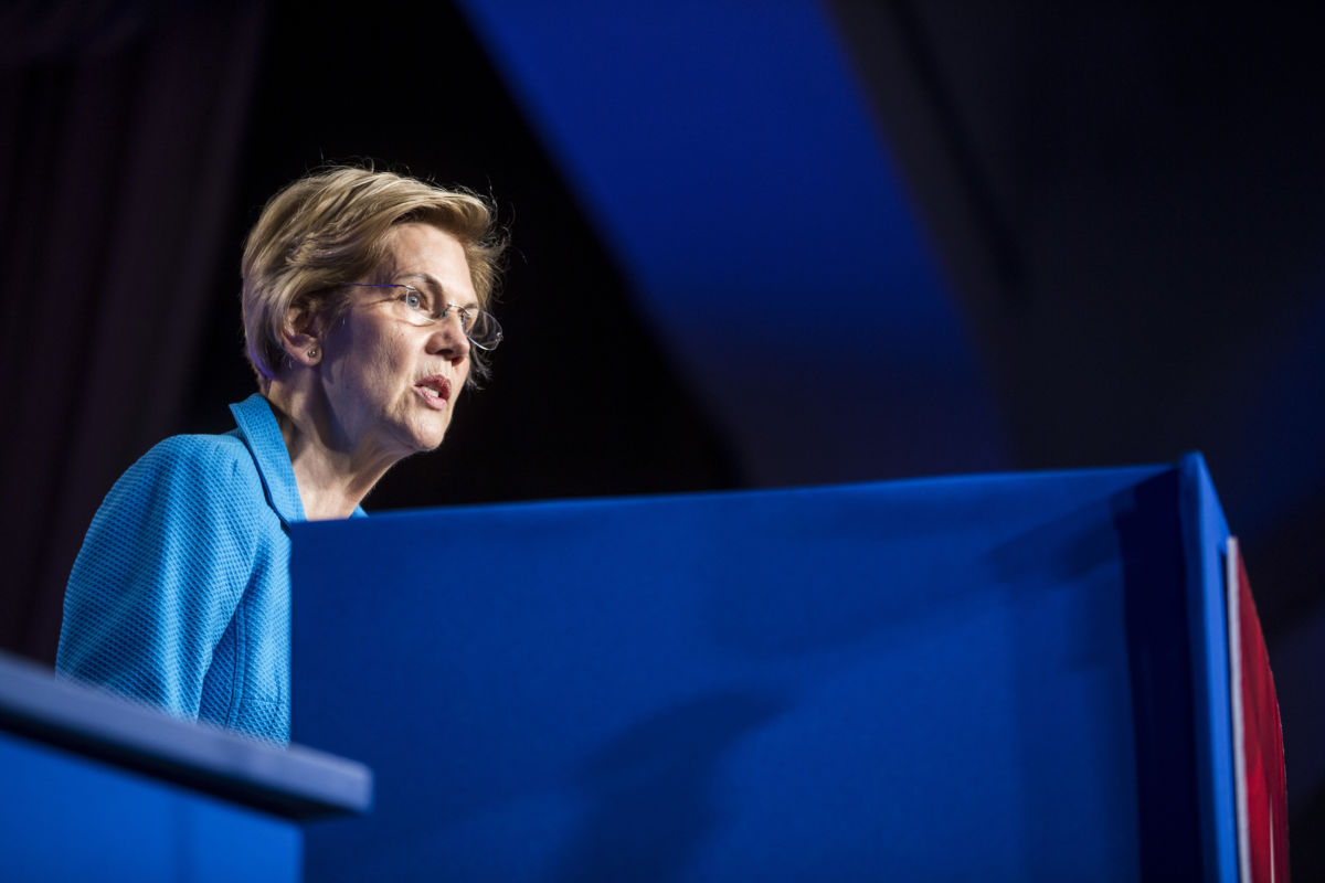 Elizabeth Warren speaks at a podium