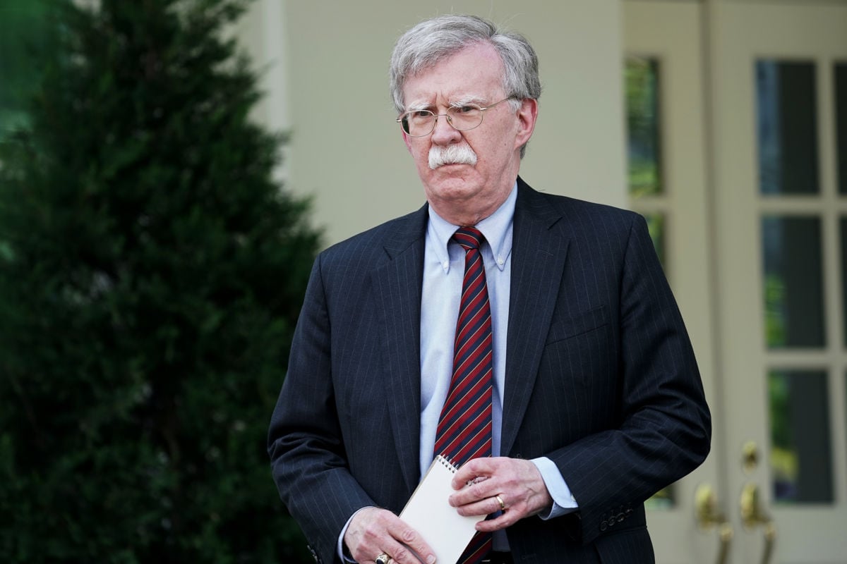 John Bolton stands outside the White House