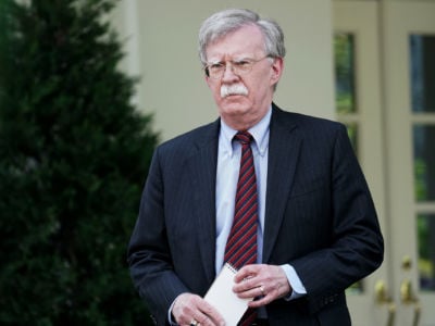 John Bolton stands outside the White House