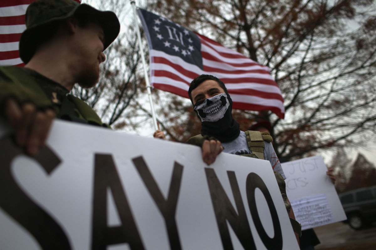 Armed anti-Muslim activists stage a demonstration in front of the Islamic Association of North Texas at the Dallas Central Mosque on December 12, 2015, in Richardson, Texas.
