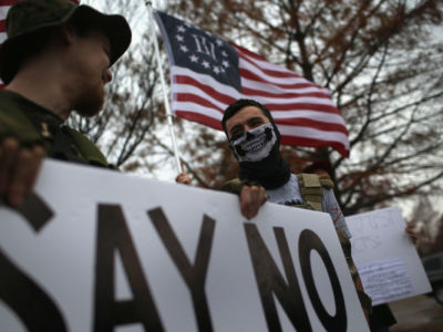 Armed anti-Muslim activists stage a demonstration in front of the Islamic Association of North Texas at the Dallas Central Mosque on December 12, 2015, in Richardson, Texas.