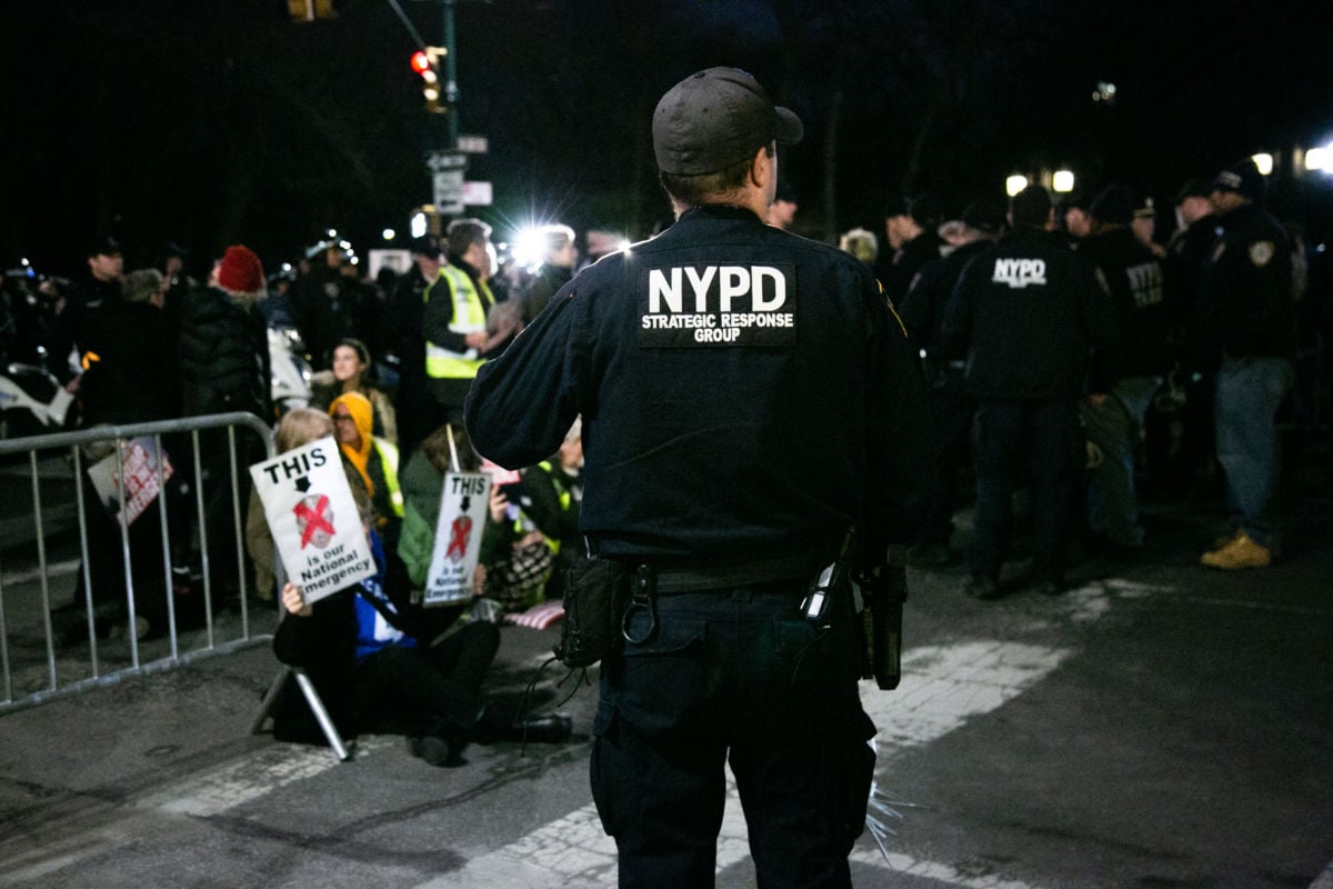 A NYPD officer stands gaurd during a protest in support of immigrants