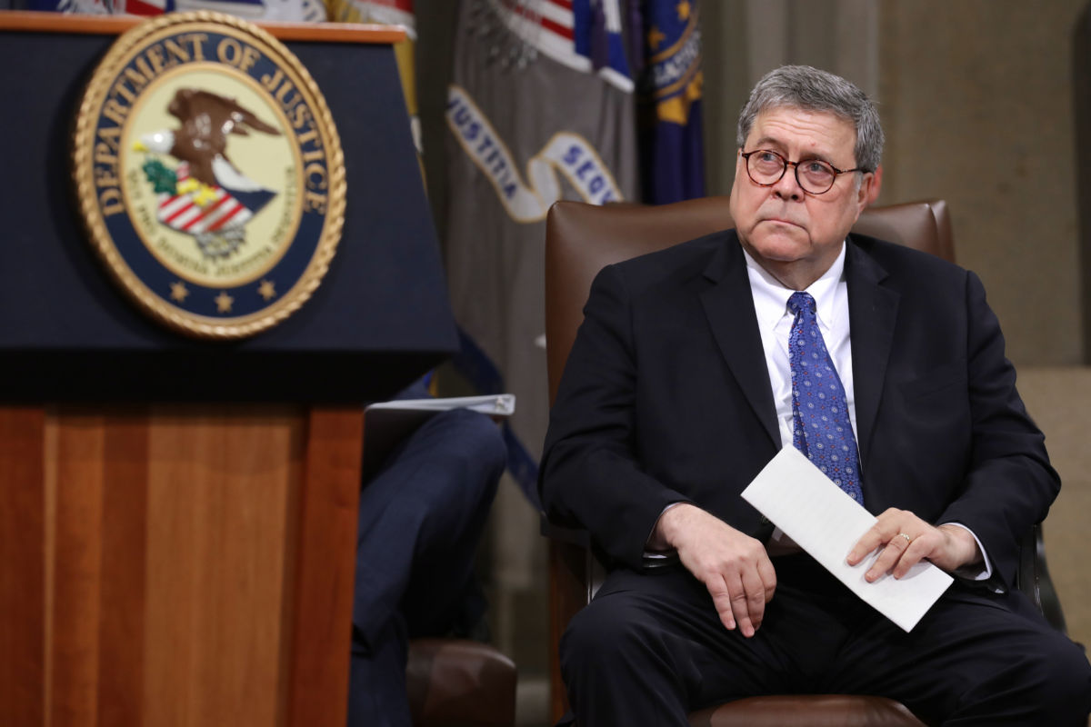 William Barr sits in a chair