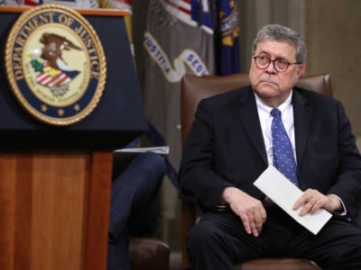 William Barr sits in a chair