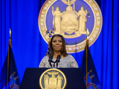 New York State Attorney General Letitia James stands at a podium