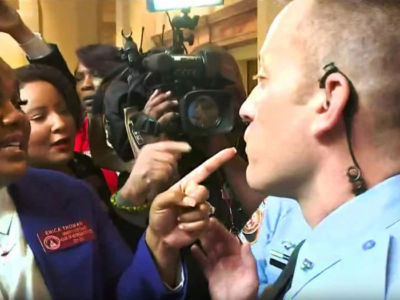 Rep. Erica Thomas argues with a group of state troopers at the Georgia capitol building on May 21, 2019. Pro-choice legislators called the heavy police presence during the abortion ban debate an intimidation tactic meant to quell their dissent.