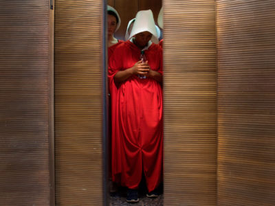 Women dressed as characters from the novel-turned-TV series "The Handmaid's Tale" stand in an elevator at the Hart Senate Office Building in Washington D.C. on September 4, 2018.