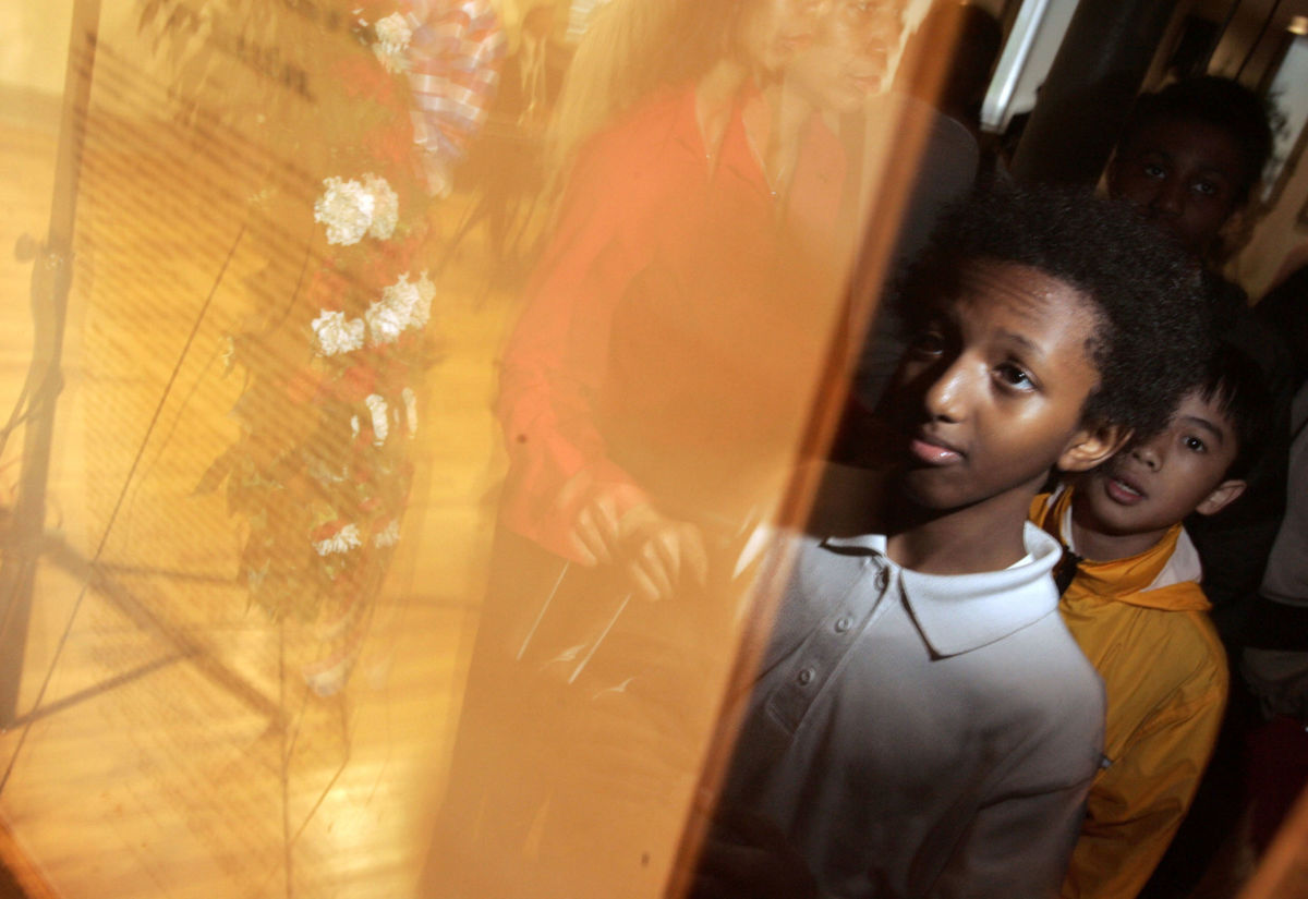 Schoolchildren line up to see an original copy of the Emancipation Proclamation signed by President Abraham Lincoln during the documents unveiling at the African American Civil War Memorial Museum, May 20, 2005, in Washington, D.C.