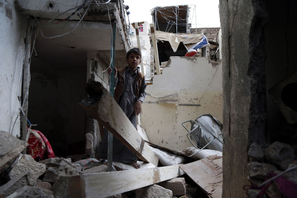 A child stands on rubble of houses a day after they were hit by airstrikes carried out by the Saudi-led coalition that left six people killed and more than 40 others injured on May 17, 2019, in Sana'a, Yemen.