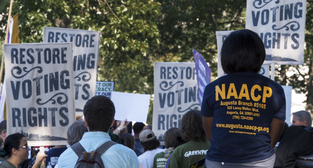 Protesters backs are seen as they march for voting rights