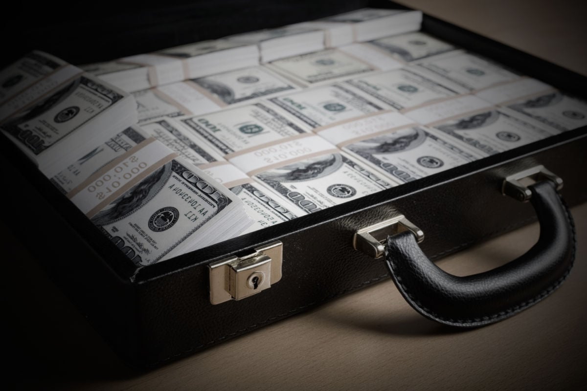 A suitcase filled with money sits open