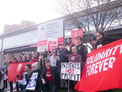 People raise their fists while displaying red signsPeople raise their fists while displaying red pro-union signs